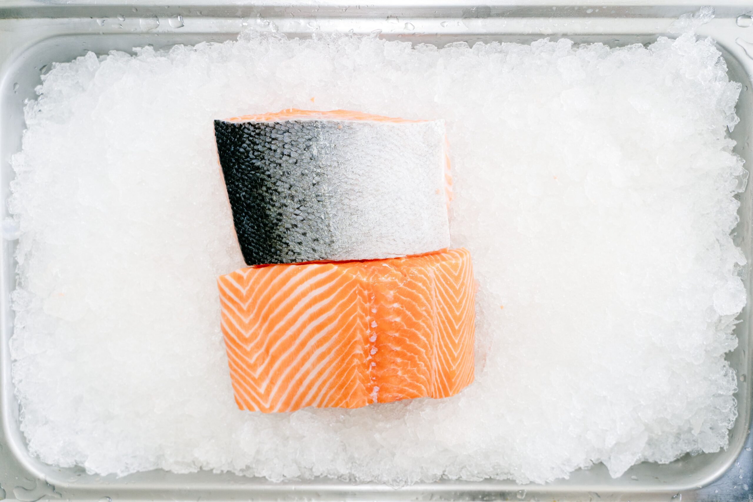 Raw salmon fillets on ice